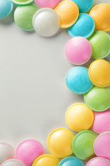 Fototapeta na wymiar Frame made of tasty colorful candies on white background