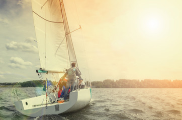 Fototapeta premium Sailing yacht race, regatta. Recreational Water Sports, Extreme Sport Action. Healthy Active Lifestyle. Summer Fun Adventure. Hobby. Team athletes participating in the sailing competition