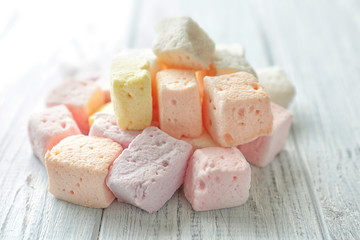 Tasty colorful marshmallows on wooden background