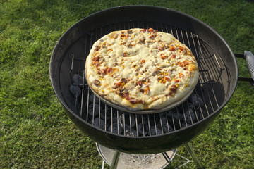 vegetable cheese pizza on grill.