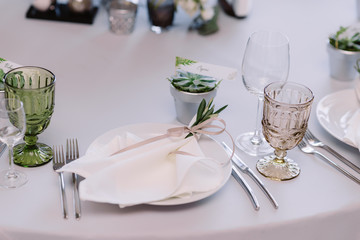 Wedding tableware, napkin with tender ribbon on the plate