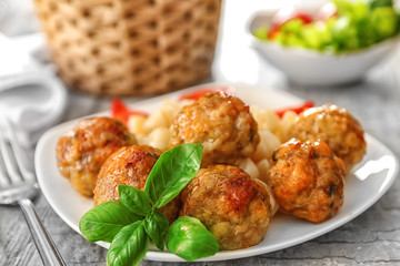 Plate with turkey meatballs and pasta on table, closeup