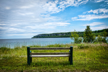 Fototapeta premium Lonely bench by the lake