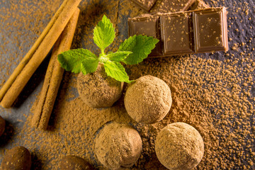 Chocolate truffle. Chocolate sweets on the table with mint and vanilla on the table