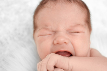 Newborn baby boy lying on soft plaid at home