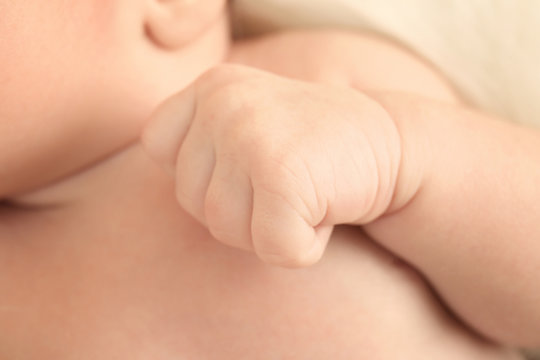 Hand of cute newborn baby boy, closeup