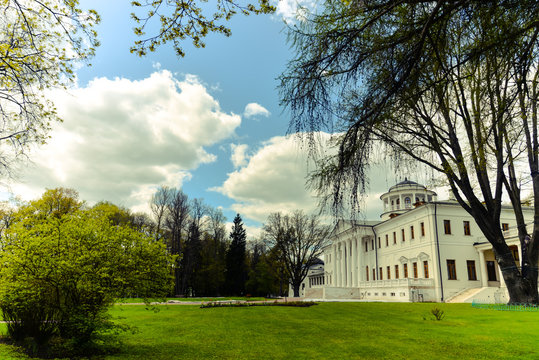View on Ostafyevo palace in Moscow region and public park. Antique mansion 18-19 century in classicism style. Beautiful landscape with old manor, lawn, sky and trees for calendars, posters, prints.
