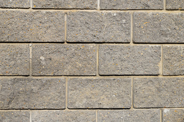 Gray bricks wall texture with yellow spots for wallpapers, background, design, template, patterns