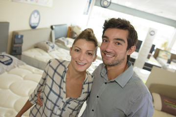 Fototapeta premium couple posing in the bed shop