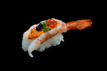 Botan ebi sushi or Spacial premium king shrimp sushi mixed by ikura and caviar top on Japanese rice. Japanese tradition food with black isolated background
