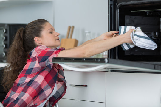 taking the food out from the oven