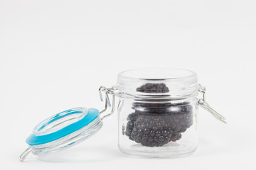 Fresh blackberries and canning jar