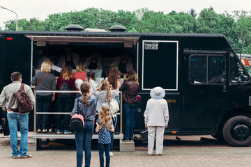 food van truck. group of people customers at mobile van with burgers and bbq at street food festival. food truck with snacks and drinks at eating market - Powered by Adobe