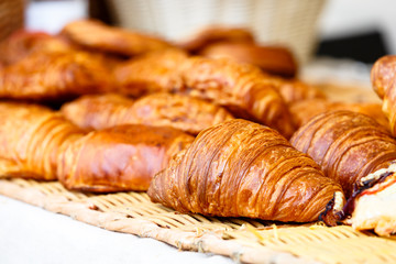 Fresh croissants lay on the counter of a small shop