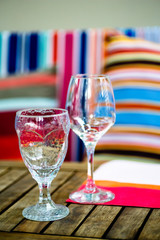 Wine glasses and a burning candle on the table, in the evening. Romance