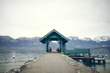 Empty pier on a lake betweens mountains