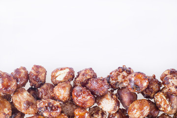 Sugared peanuts on white background - Arachis hypogaea