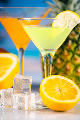 Yellow and orange drink with fruits, summer time background