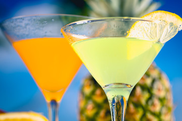 Yellow and orange drink with fruits, summer time background