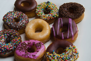 Donuts on white plate. Close up.