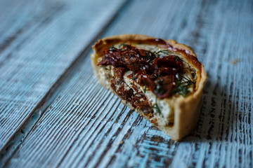Australian meat pie on the table, a horizontal top view, rustic style. Homemade australian meat pie on the wooden table. Delicious cut meat pie on a plate. American Chicken pot pie