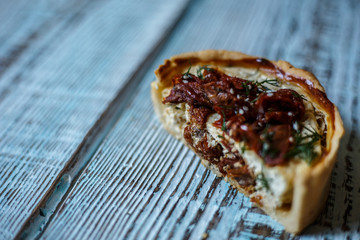 Australian meat pie on the table, a horizontal top view, rustic style. Homemade australian meat pie on the wooden table. Delicious cut meat pie on a plate. American Chicken pot pie