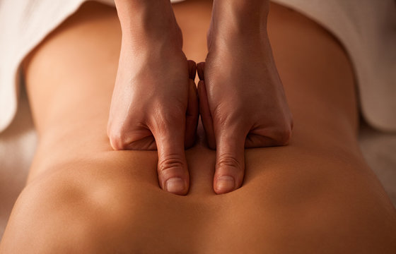 Close up of a woman receiving back massage at spa