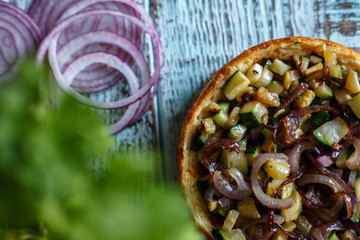 Australian meat pie on the table, a horizontal top view, rustic style. Homemade australian meat pie on the wooden table. Delicious cut meat pie on a plate. American Chicken pot pie