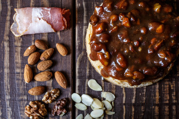 Australian meat  pie on the table and avocado, chilli, chips, rustic style. Homemade meat pie on the wooden table. Delicious cut meat pie on a plate. American Chicken pot pie