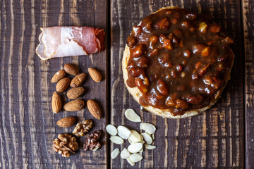 Australian meat  pie on the table and avocado, chilli, chips, rustic style. Homemade meat pie on the wooden table. Delicious cut meat pie on a plate. American Chicken pot pie