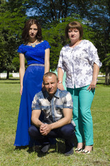 Fototapeta na wymiar Mother, father and adult daughter in the park area.