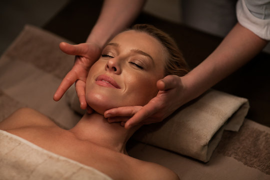 Woman receiving a face massage at spa