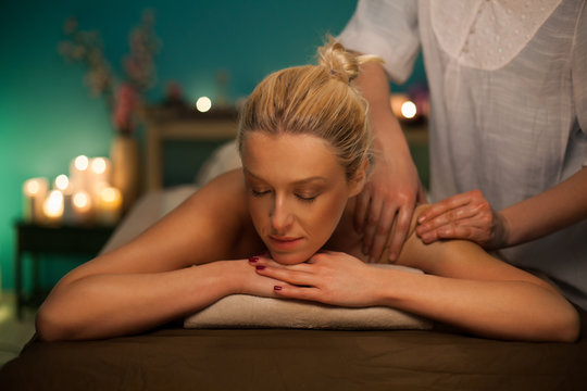 Woman receiving a back massage at spa