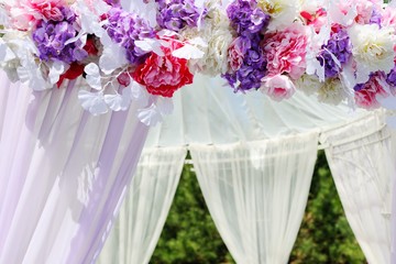 Lilac, pink and red flowers close-up on wedding arch. wedding decorations