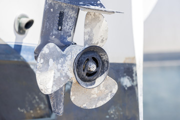 Closeup of white boat propeller peeling and chipped