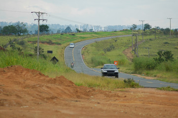 small road and three vehicles