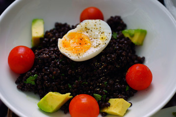 Beluga lentil salad with a soft boiled egg on top