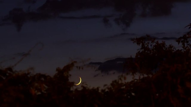 The Moon Down. Nice crescent moon through passing clouds. High definition,