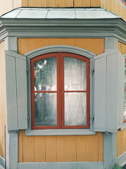 Brown window with grey persienne 