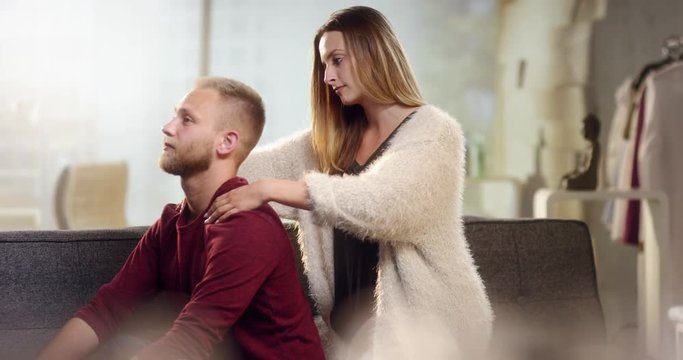 Young woman gives his boyfriend a beautiful neck massage