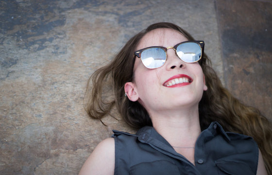 Young modern woman with sunglasses and casual expression