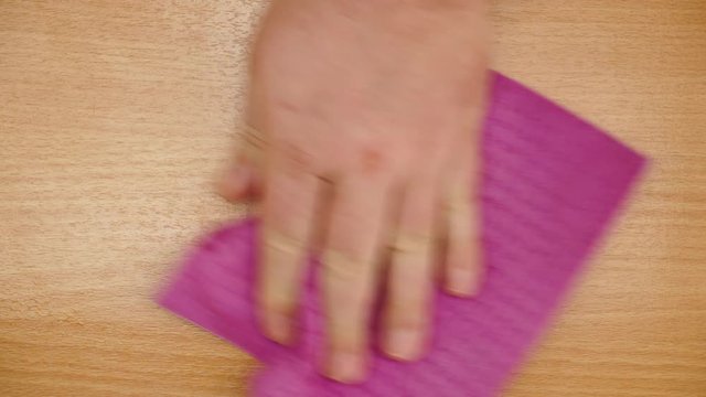 Male hand cleaning table with rag at home kitchen, view from above. People, housework and housekeeping concept. 4K ProRes HQ codec