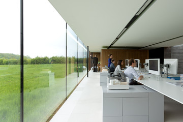 Interior of a glass fronted office with employees working