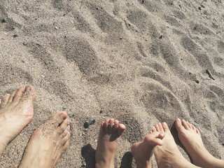 Feet on sandy beach 