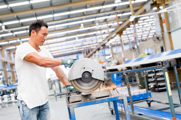 Asian worker in production plant on the factory floor