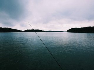 Fishing rod on calm sea view 