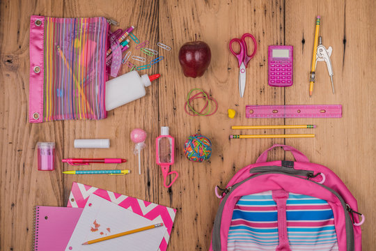 Overhead view of school supplies on the wooden table
