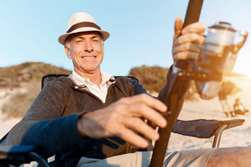 Senior man fishing at sea side