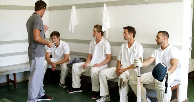 Coach interacting with cricket players