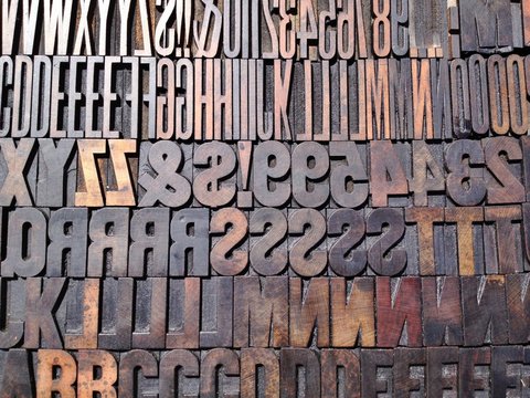 Vintage wooden printing letter blocks in various typefaces.